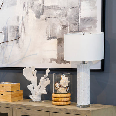 Lámpara Estriada de Cerámica Blanca, lámpara de líneas limpias, tonos monocromáticos, lámpara de loza cerámica, acero inoxidable, cobre, PVC, algodón y cristal acrílico, ofrece durabilidad, diseño refinado, lámpara de cuerpo cilíndrico texturizado, acabado blanco con detalles metálicos en plata, base de cristal transparente, pantalla blanca brillante, emite una luz cálida, armoniosa.